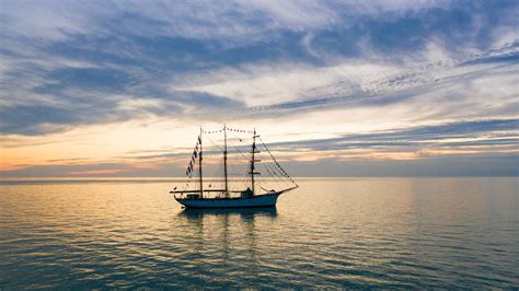 Sailboat On Sea Under Cloudy Gray Sky During Sunset Hd Nature