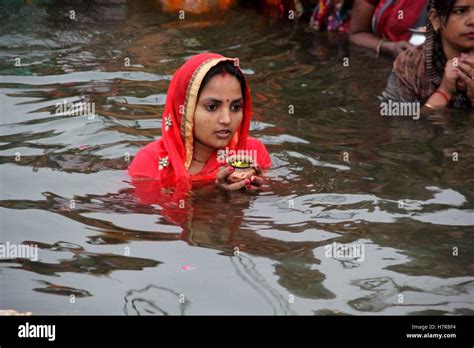Hindu Devotees Offer Prayers To Suraya Dev On Rising Sun In The Waters