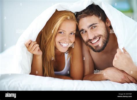 Portrait Of Young Couple Under The Sheet Stock Photo Alamy