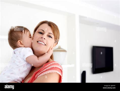 Mother Holding Baby And Baby Cuddling Mother At Home Stock Photo Alamy