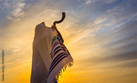 blowing the shofar man in a tallith jewish prayer shawl is blowing the shofar ram s horn