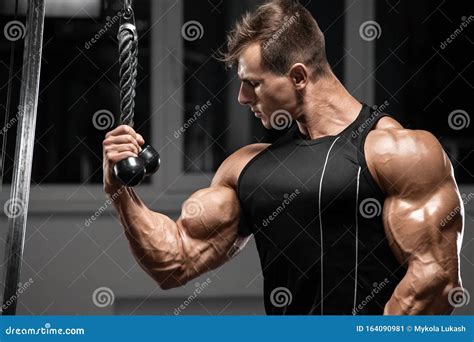 Muscular Man Workout In Gym Doing Exercises For Biceps Strong