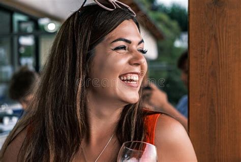 Portrait Side View Of A Young Beautiful Smiling Tanned Brunette A