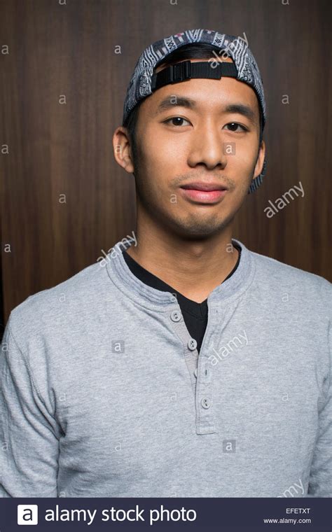 Portrait Of Smiling Man Wearing Backward Baseball Cap Stock Photo Alamy