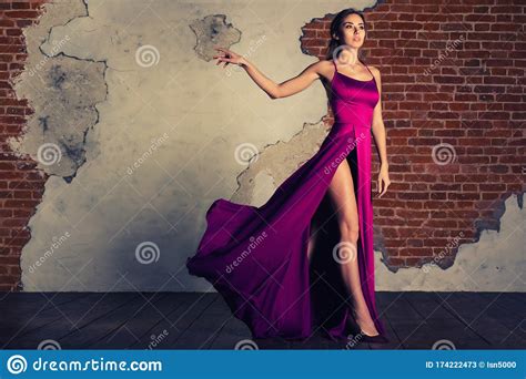 Model In Elegant Dress Woman Posing In Flying Silk Cloth Waving On