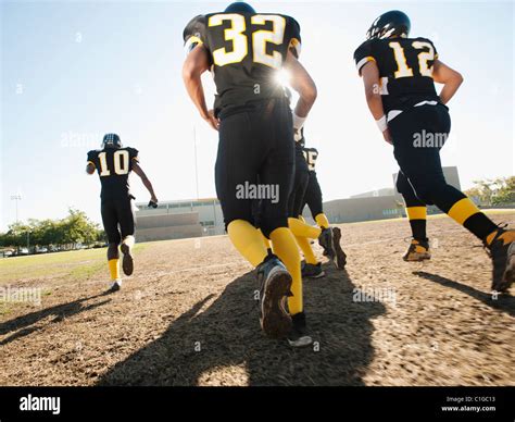 Football Players Running On Football Field Stock Photo Alamy