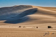 Wind blows stong over the dunes of the namib desert of Namibia. Winds ...