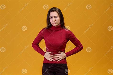 An Attractive Young Woman Grabbed Her Stomach From Pain Of Lower