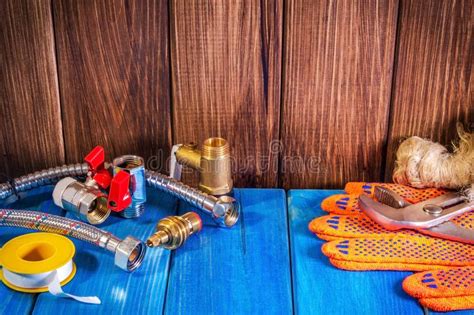 Plumbing Supplies And Tools On A Blue Wooden Background Close Up Stock