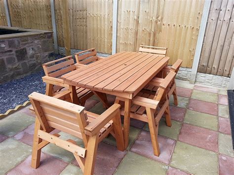 Wooden white restaurant table with four chair on wooden terrace. Furniture Round Wooden Outdoor Table And Chairs Timber ...