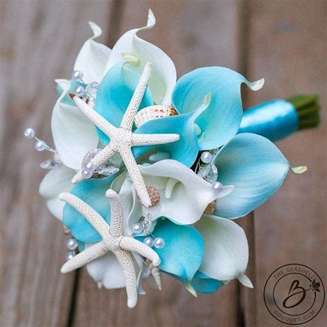 A Bridal Bouquet With Blue Flowers And Starfish