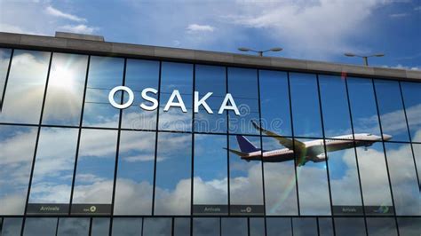 Airplane Landing At Osaka Japan Airport Mirrored In Terminal Stock