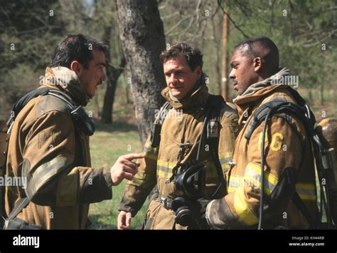 Three Firefighters Talking After Fighting A Fire Stock Photo Alamy