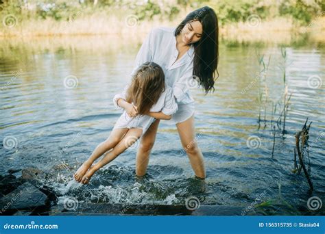 Mother And Daughter Play And Have Fun In The Water On A River Stock Image Image Of Daughter