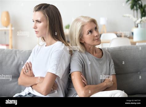 Mother And Daughter Sitting On Couch After Quarrel Stock Photo Alamy