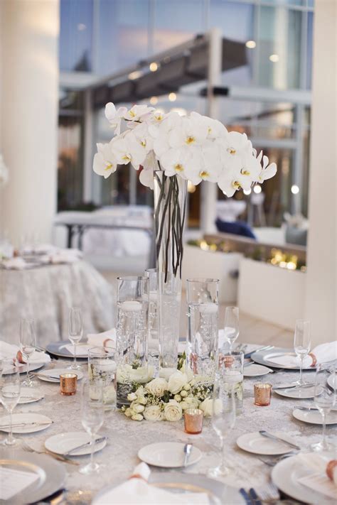 White Orchid Centerpieces In Tall Hurricane Vases Orchid Centerpieces