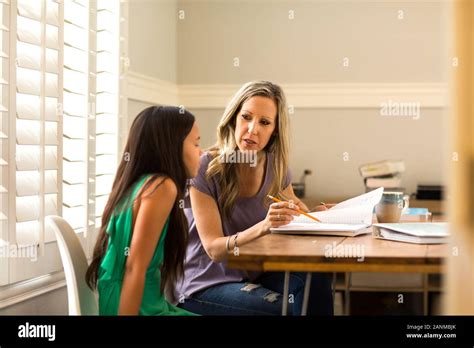 Teacher Helping Her Student With Her Homework Stock Photo Alamy
