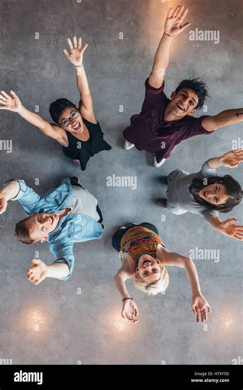 Overhead View Of Young People Standing Together Looking Up At Camera