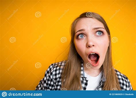 A Girl With Long Hair Is Surprised And Opens Her Mouth In Amazement With Resentment Stock Image