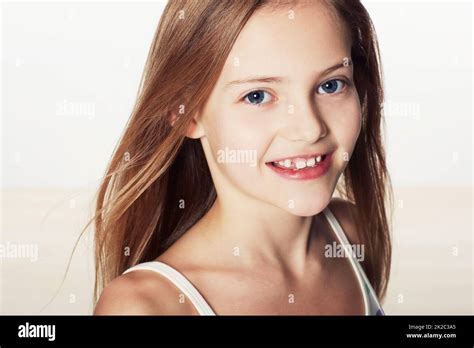 Sweet And Innocent Cropped Portrait Of A Cute Little Girl Smiling