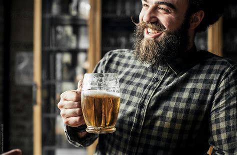 Man Drinking Beer At Smiling Bar By Stocksy Contributor Lumina Stocksy