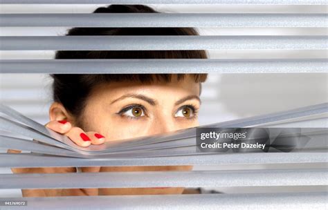 Obsessive Woman Spying On Her Neighbour Through Window High Res Stock
