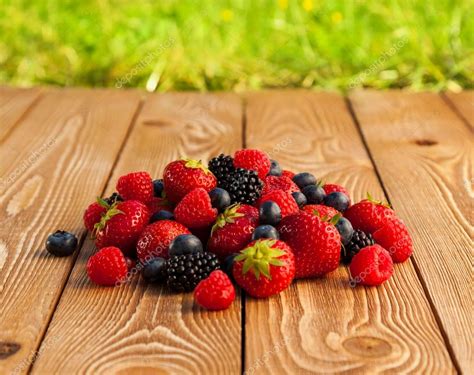 Berries On Wooden Background Stock Photo By ©vadmary 29353325