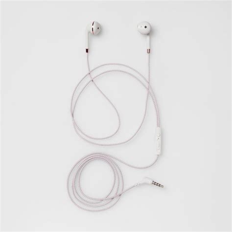 The Ear Buds Are Plugged In And Attached To The Headphones On The White Surface