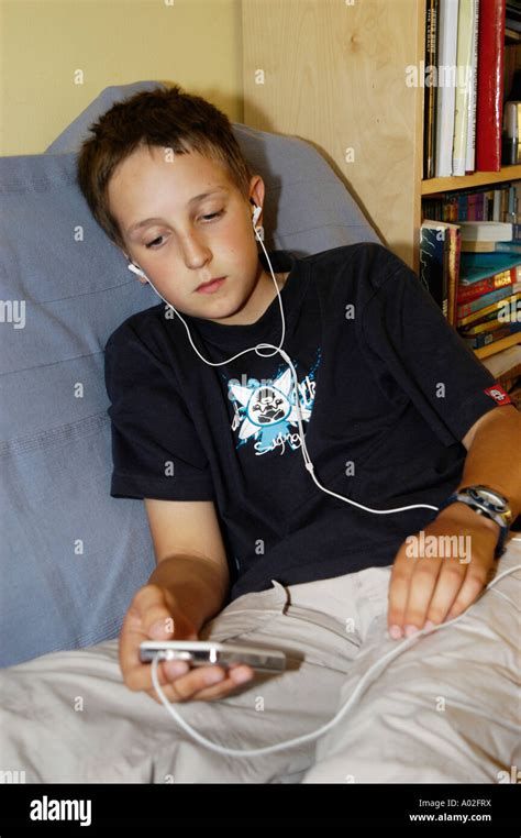 Young Boy Listening To His Ipod At Home Stock Photo Alamy