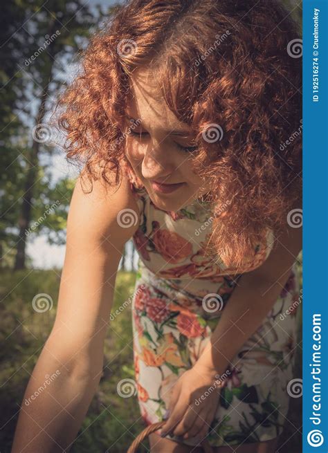 Red Haired Curly Haired Girl In A Summer Dress Posing In The Village