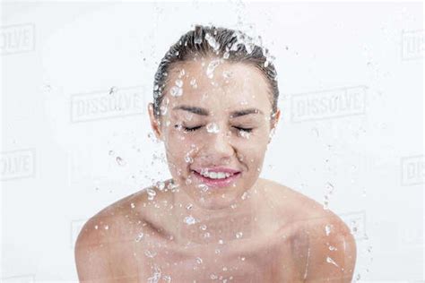 Portrait Of Smiling Woman Taking Shower Isolated On White Stock Photo