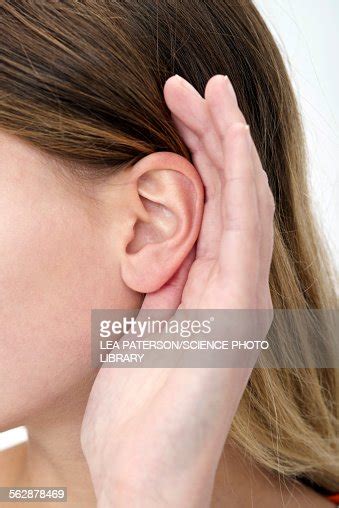 Woman With Hand Cupping Ear High Res Stock Photo Getty Images