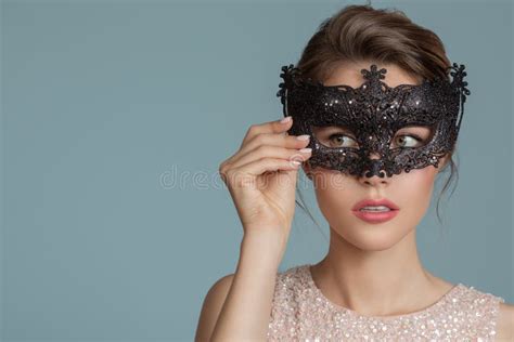 Beautiful Woman With Carnival Black Mask On Her Face Stock Photo