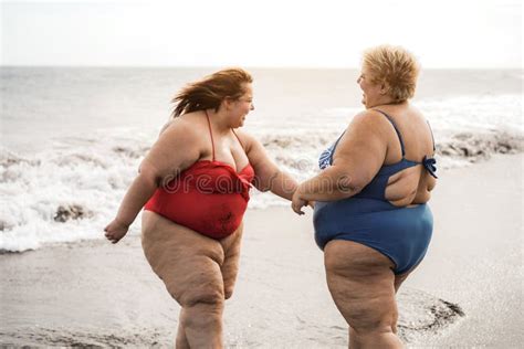 Plus Size Women Sitting On The Beach Having Fun During Summer Vacation