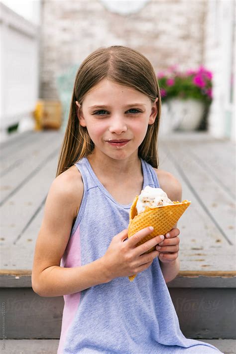 Treat Cute Girl Eating Ice Cream Cone By Stocksy Contributor Sean