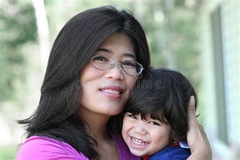 Asian Mother Lovingly Holding Her Son Stock Image Image Of Smiling