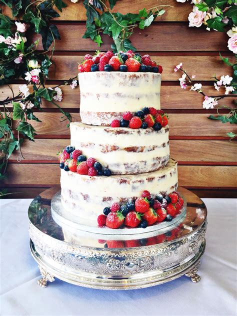 Semi Naked Wedding Cake With Fresh Berries And Dusting Of Powedered