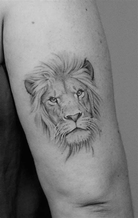 A Black And White Photo Of A Lion Tattoo