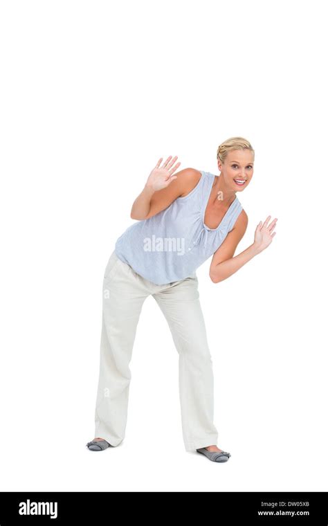 Blonde Woman Bending Down With Hands Up Stock Photo Alamy