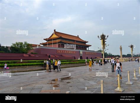 Tourists Walk Past The Tiananmen Rostrum In Beijing China 12 June