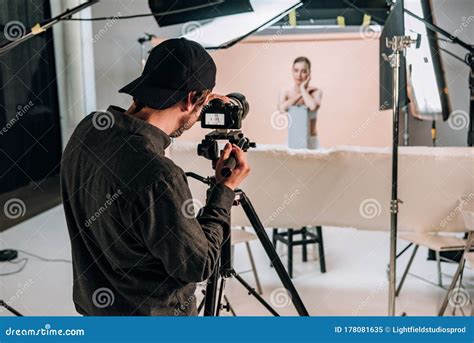 Focus Of Cameraman Filming Beautiful Model In Photo Studio With