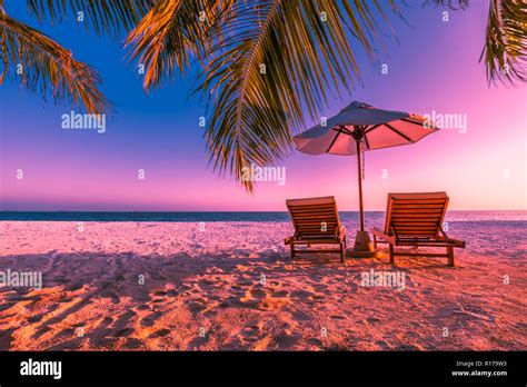 Perfect Sunset Beach Two Sun Chairs With Umbrella Under Palm Trees