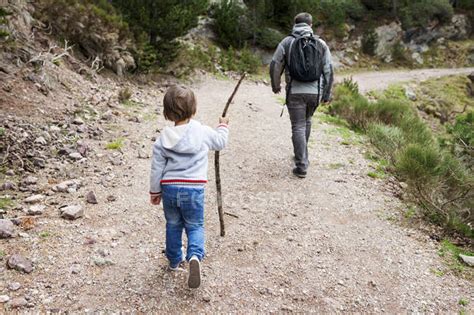 Father And Son Hiking On Rural Path — Caucasian Appearance Stroll