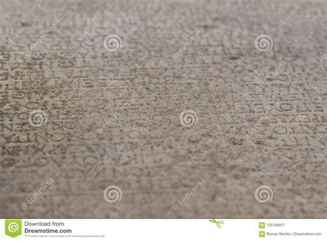Ancient Alphabets Carved On A Stone Plate Background Stock Image