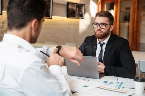 Two Businessmen Working Together On Business Meeting In Office Stock