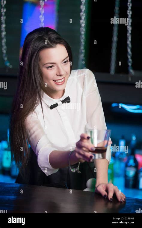 Beautiful Cheerful Brunette Bartender Girl In White Shirt And Black Bow