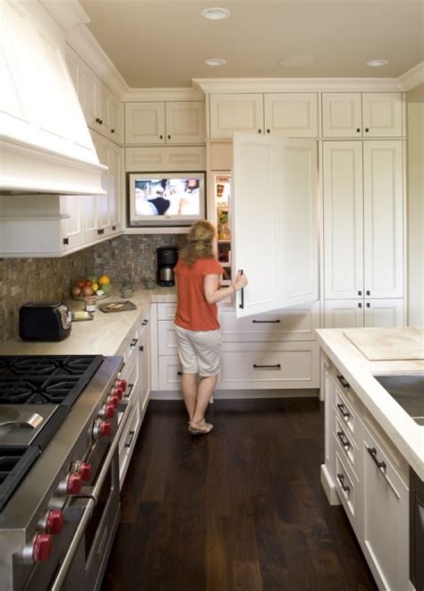 Under cabinet tv a space saving option for any home kitchen an under cabinet tv is a television specifically designed to hang underneath a kitchen cabinet. TV in KItchen - Transitional - kitchen - Mueller Nicholls
