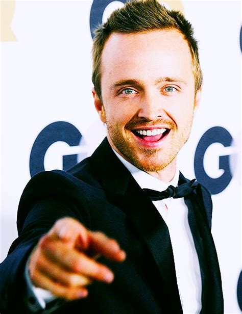 A Man In A Tuxedo Pointing At The Camera With His Hand Out And Smiling