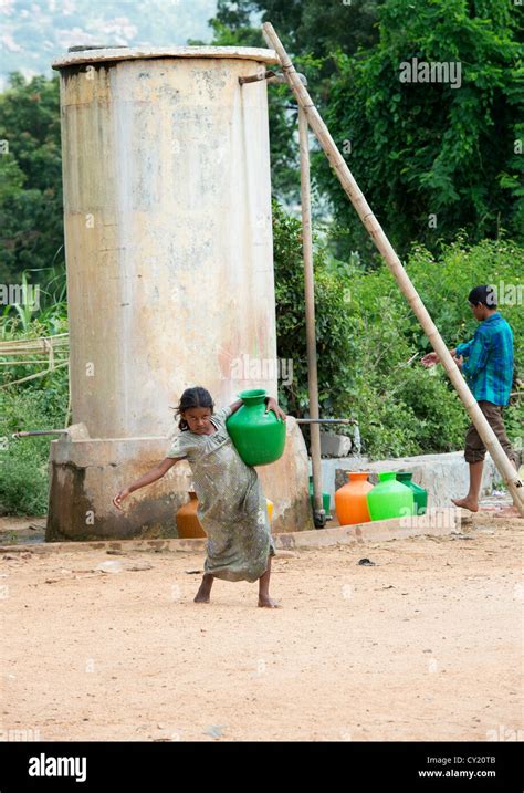 Young Rural Indian Village Girl Collecting Water From A Communal Water Tank Andhra Pradesh