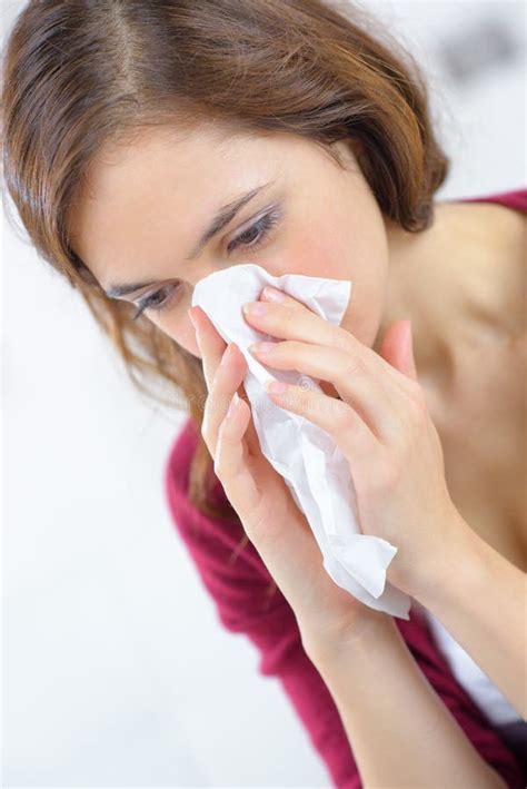 Burnette Woman Blowing Nose Into Tissue Stock Photo Image Of Female